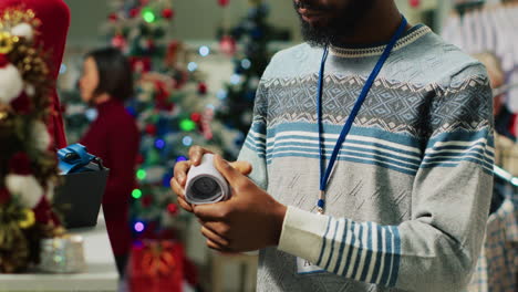 Portrait-of-smiling-employee-in-Christmas-decorated-clothing-store-arranging-neckties.-Cheerful-fashion-shop-worker-preparing-merchandise-for-holiday-season-shopping-frenzy