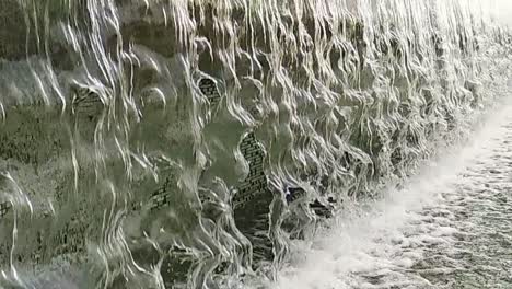 close-up or fountain water drops to small pool in the city