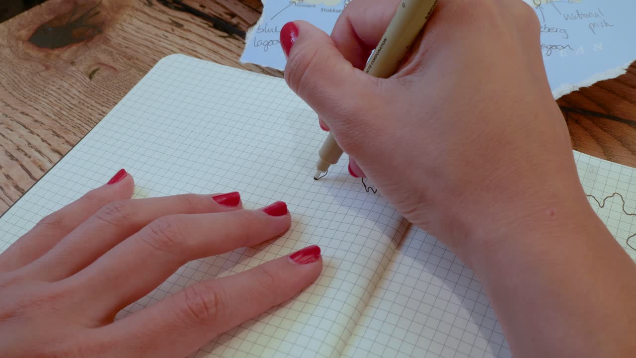 Woman writes in her travel journal