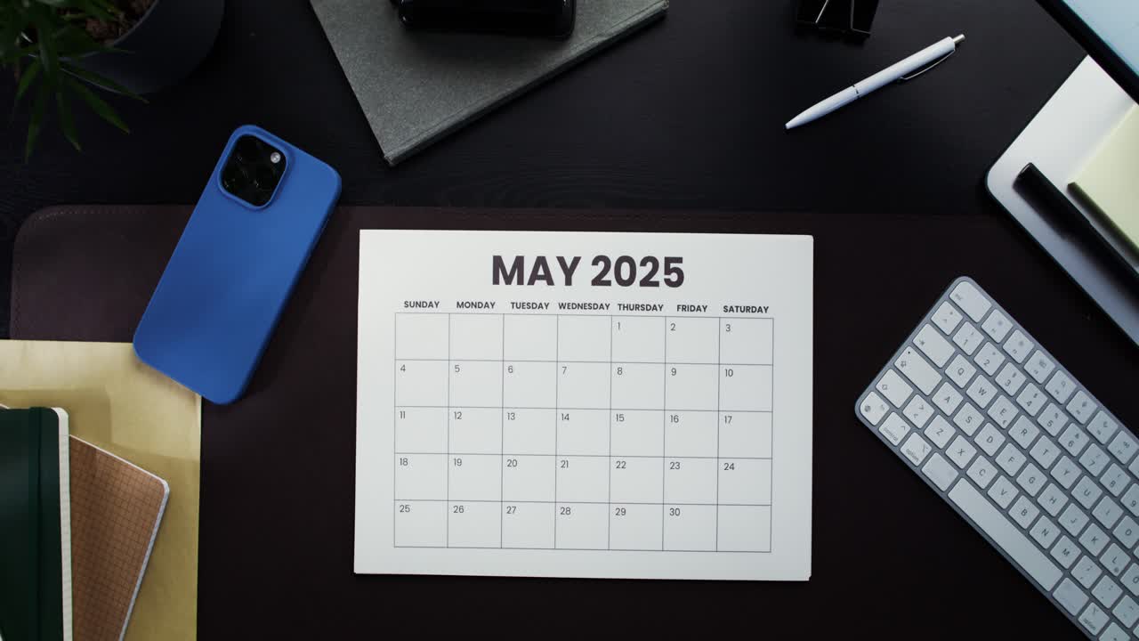 Busy Desk with Calendars for April and May 2025