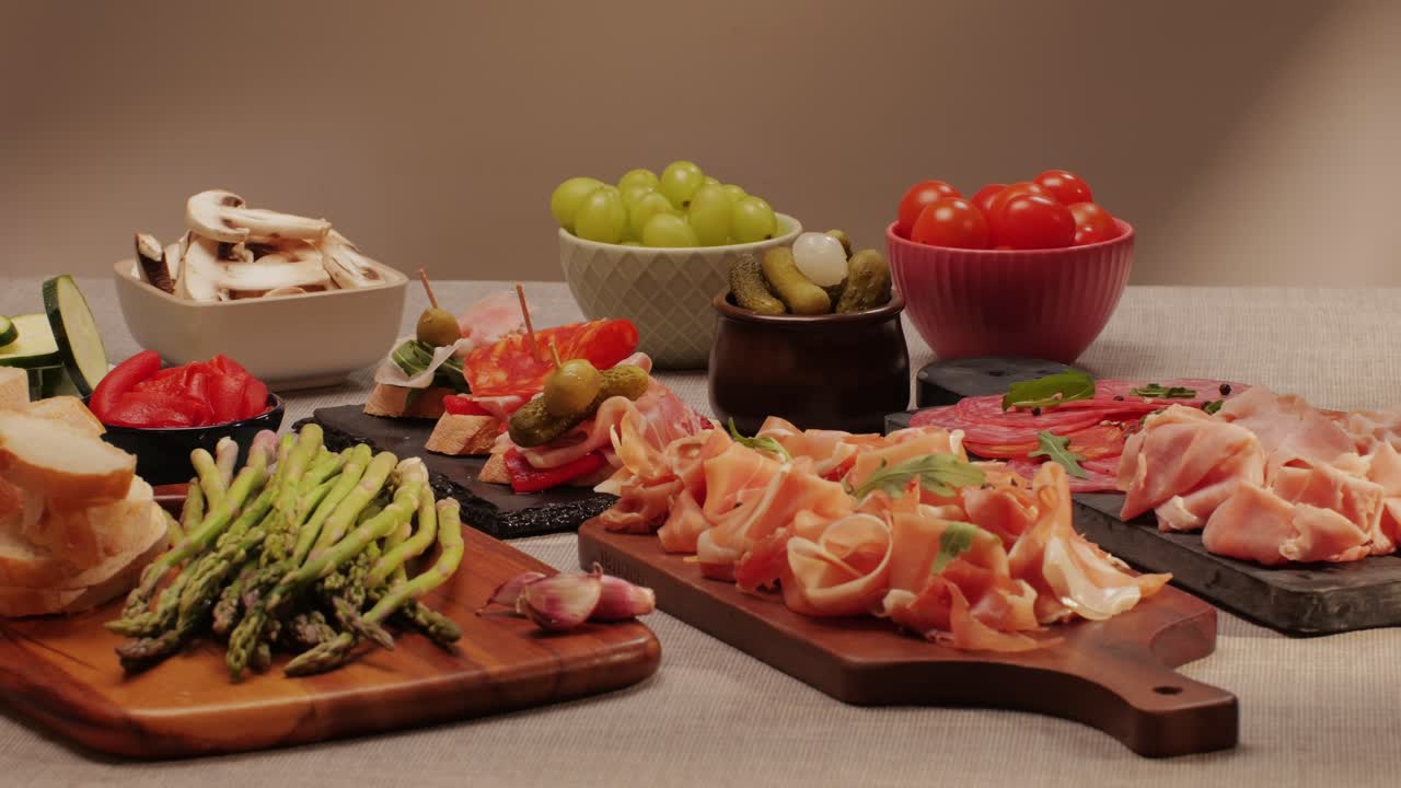 Italian or Spanish restaurant with traditional tapas food, Spanish cuisine, delicious tapas and cheese plate, bruschetta with cheese, olives dry tomatoes and tasty sandwich bar appetizer, buffet