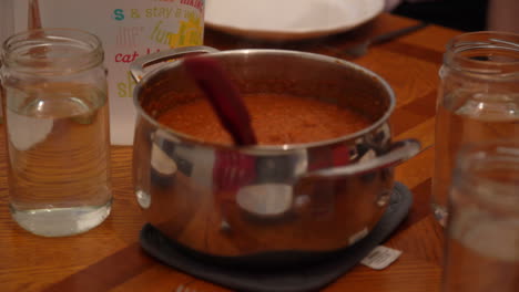 bowl of red pasta sauce at dinner table