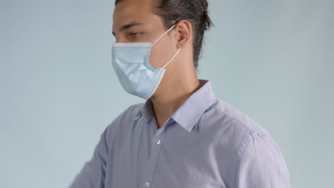 close up view of a young man wearing a face mask