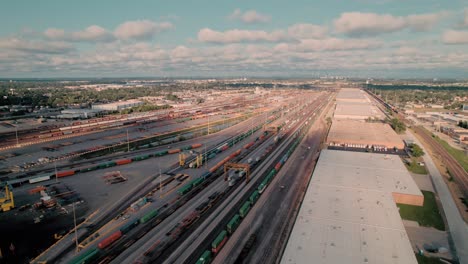 forward aerial of intermodal terminal rail road with yard full of containers with chicago in background