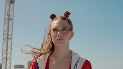 portrait red head woman with freckles looking serious with wind blowing hair teenage girl in city self image testimonial