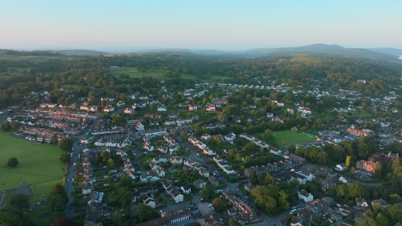 Rural town amongst woodland and hills at sunrise. Summer. Windermere, Cumbria, UK