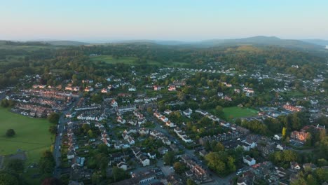 rural town amongst woodland and hills at sunrise. summer. windermere, cumbria, uk