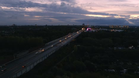 morning traffic on a40 highway at dawn, aerial view with dortmund city skyline