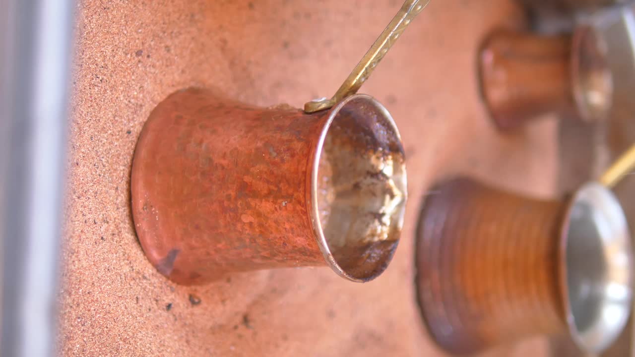 Turkish coffee being made in hot sand