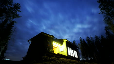 Blue-Night-Sky-And-Cloudscape-Time-Lapse-Over-Small-Deserted-Cabin,-Lapland-Finland