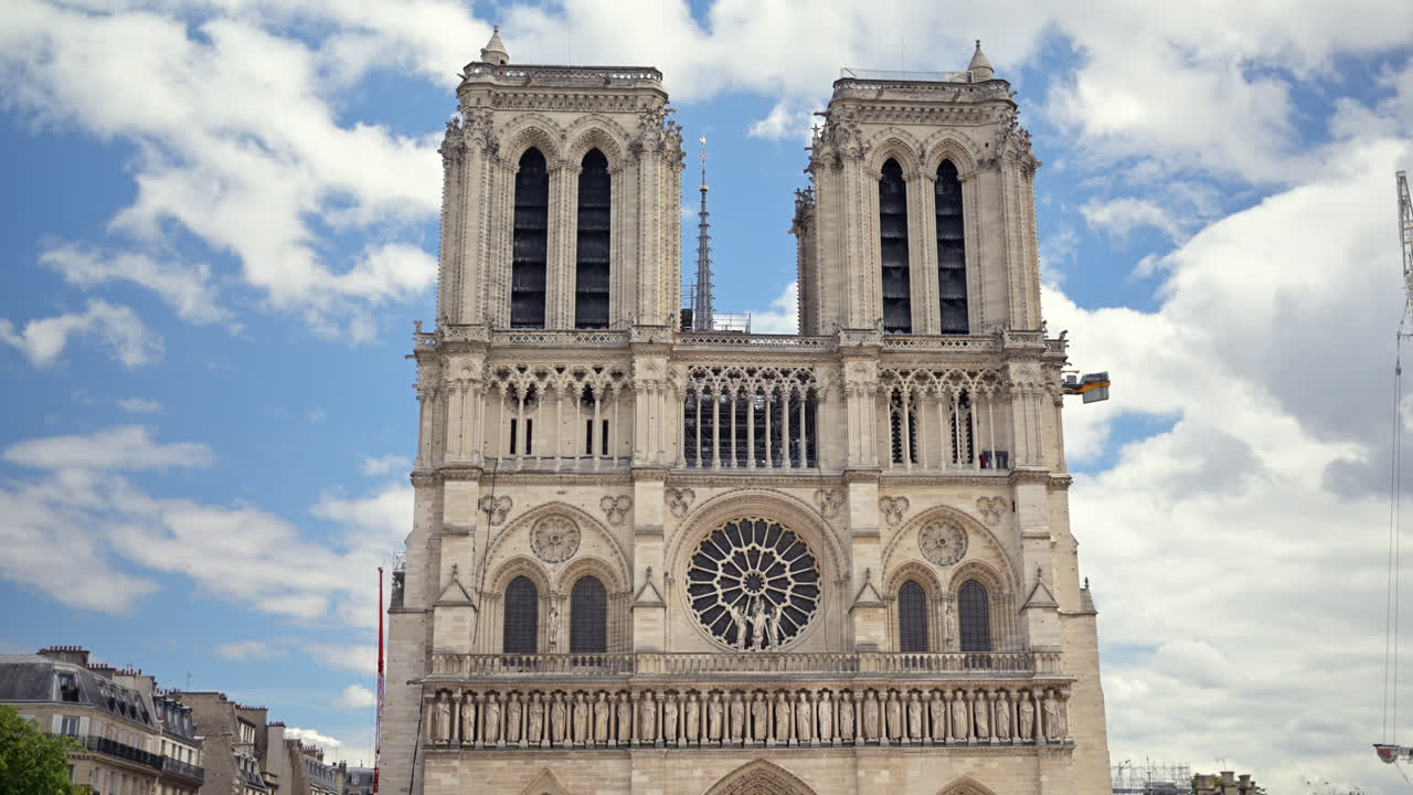 The facde of the Cathedrale Notre-Dame de Paris in France with the blue sky on the background