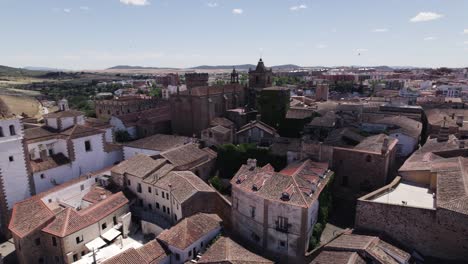 Reverse-aerial-View-across-Caceres-medieval-cityscape,-UNESCO-World-Heritage-In-Extremadura,-Spain