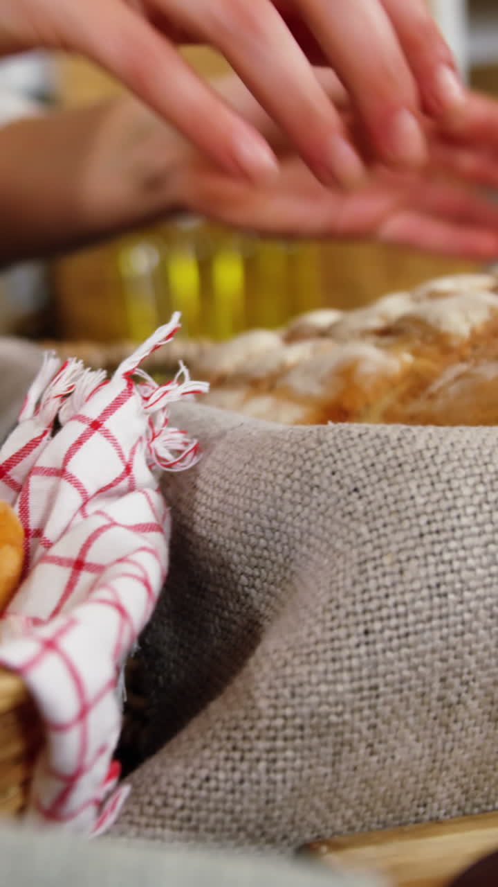 Mid section of female staff working at bakery section