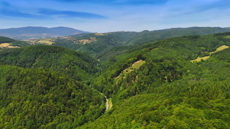 vast green hills under a clear blue sky. lush green hills stretch across the landscape, showcasing serene valleys and distant mountains on a sunny day