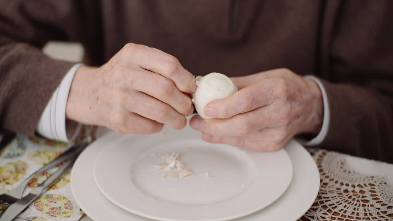 Old Man Peeling Egg On Plate 2