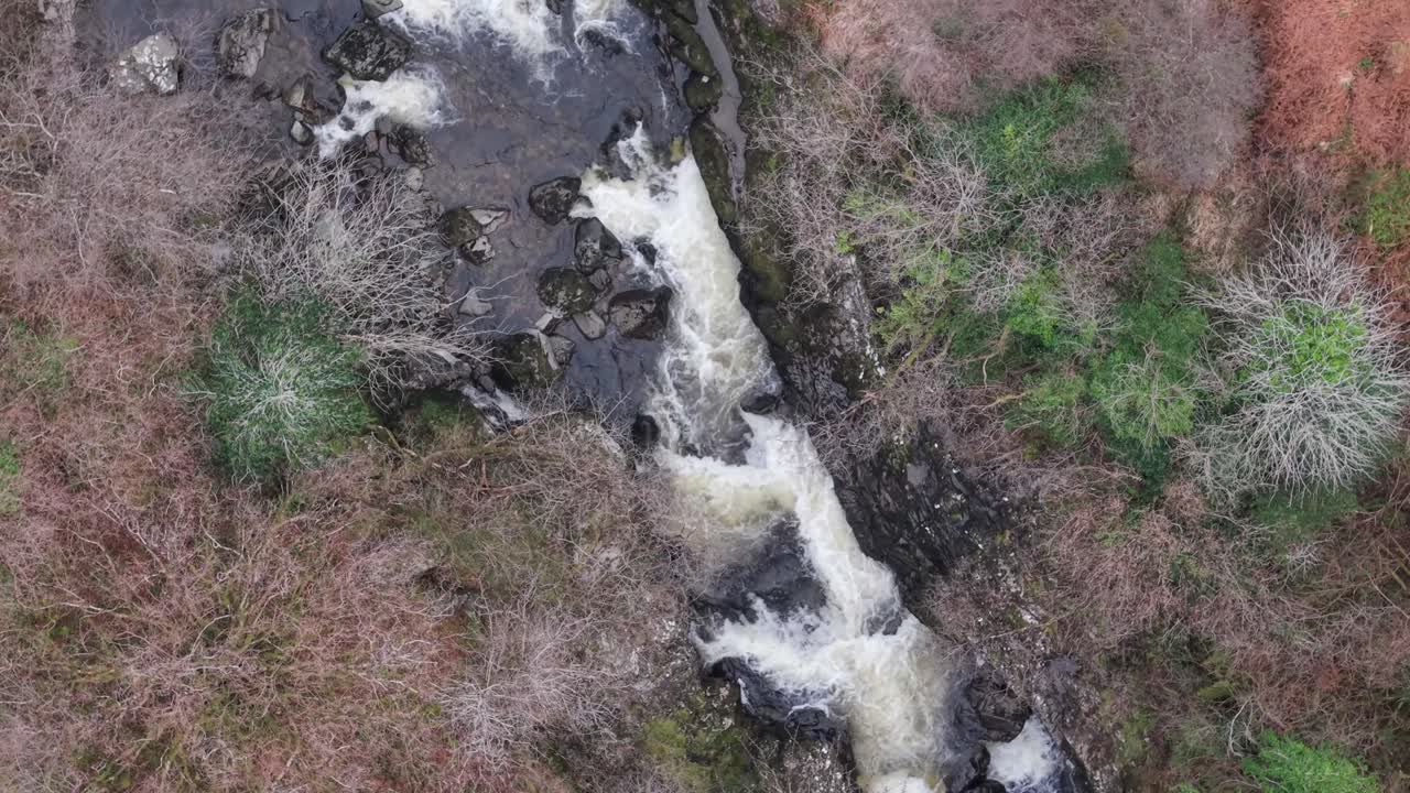 A flowing stream amidst lush, rugged landscape in county kerry, ireland , aerial view