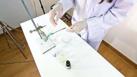 a scientist conducts a chemical reaction between copper carbonate and sulfuric acid in a laboratory setting