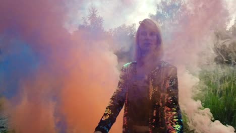 calmer slow motion cinematic shot of a jung woman standing in a thick wall of orange and blue fog.colorful fog shooting. foto video shoot on lost places in wild nature 1080, 24p by philipp marnitz
