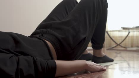 Woman-doing-exercises-on-the-floor-with-mat