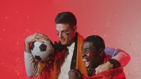 animation of confetti over diverse footballers celebrating with flags of germany and portugal