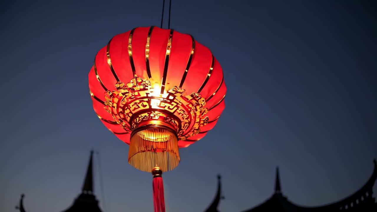 Low-angle shot of a glowing red lantern against a twilight sky, capturing a traditional and festive