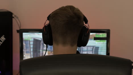 overshoulder shot of kid playing video game on pc