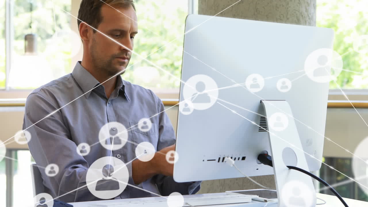 Animation of network of profile icons over caucasian man talking on smartphone at office