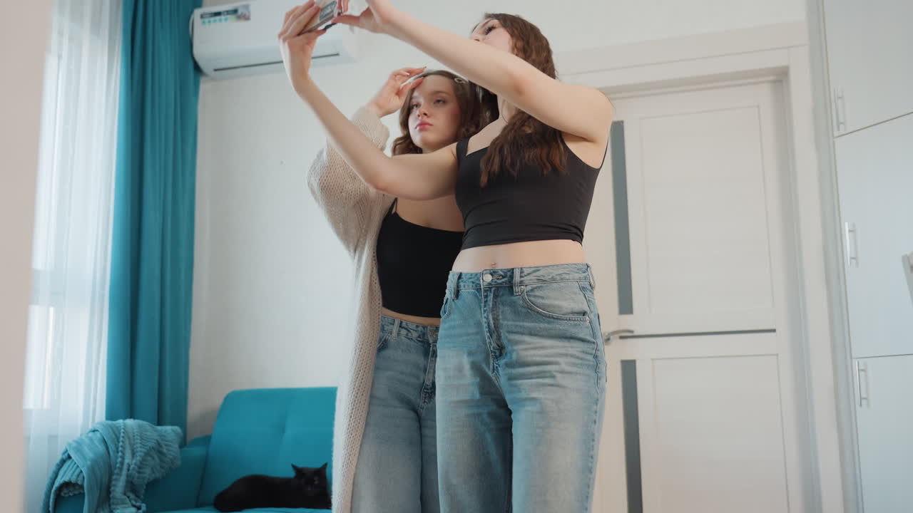 Two Women Capturing Stylish Photos With Natural Light And Joyful Expressions, Charming Mirror Selfie Featuring Women In Trendy Outfits Enjoying Natural Sunlight In Cheerful Environment