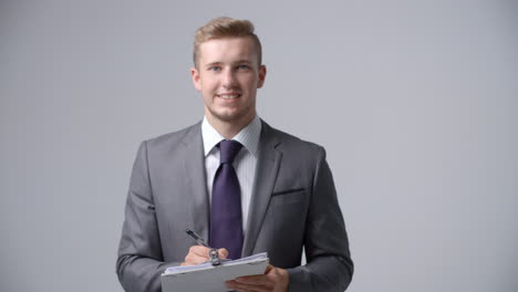 Slow-Motion-Sequence-Of-Businessman-With-Clipboard