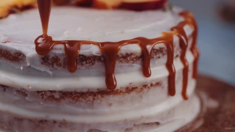 cake decoration - pastry chef squeezing caramel icing on a round cake