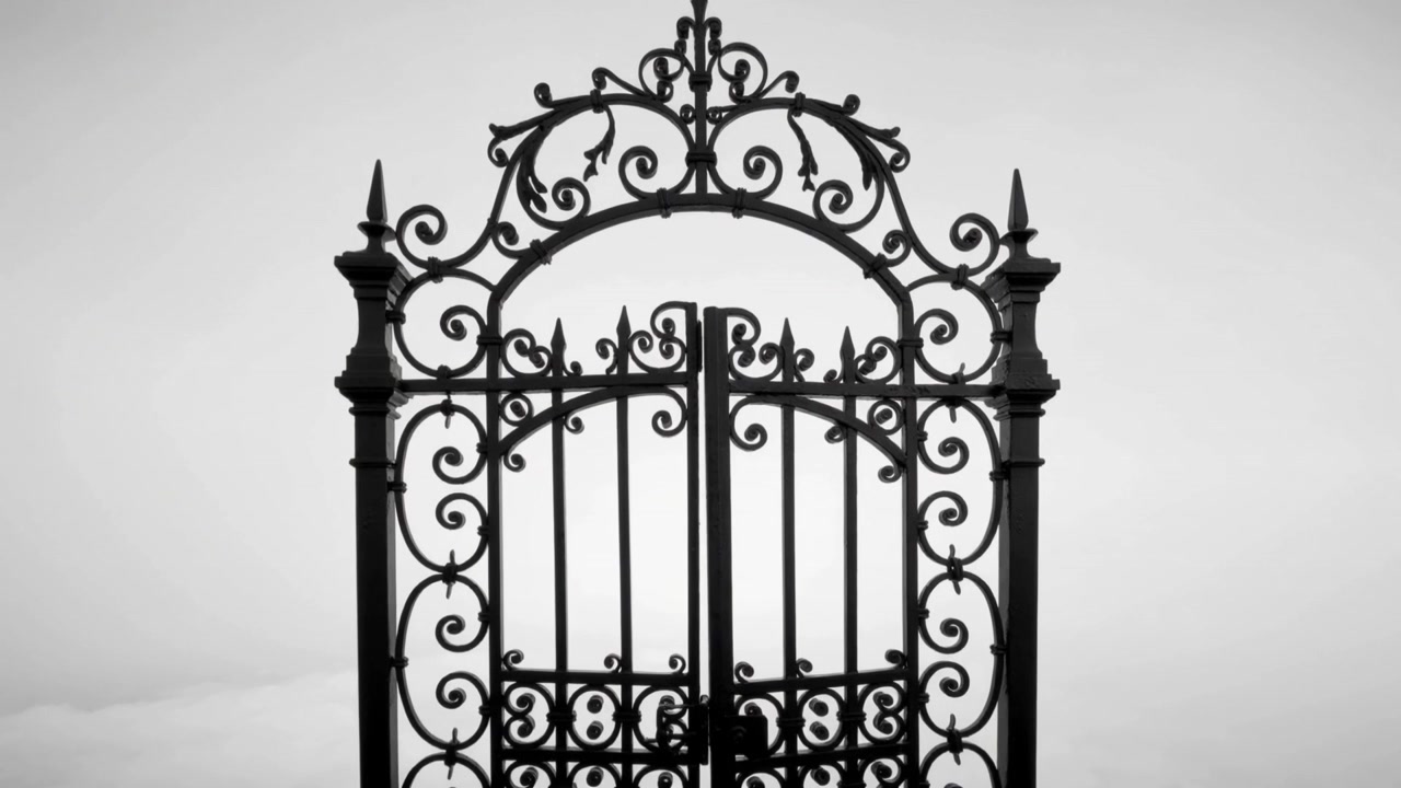 Displaying wrought-iron gate remaining closed in studio, showcasing scrollwork and central latch