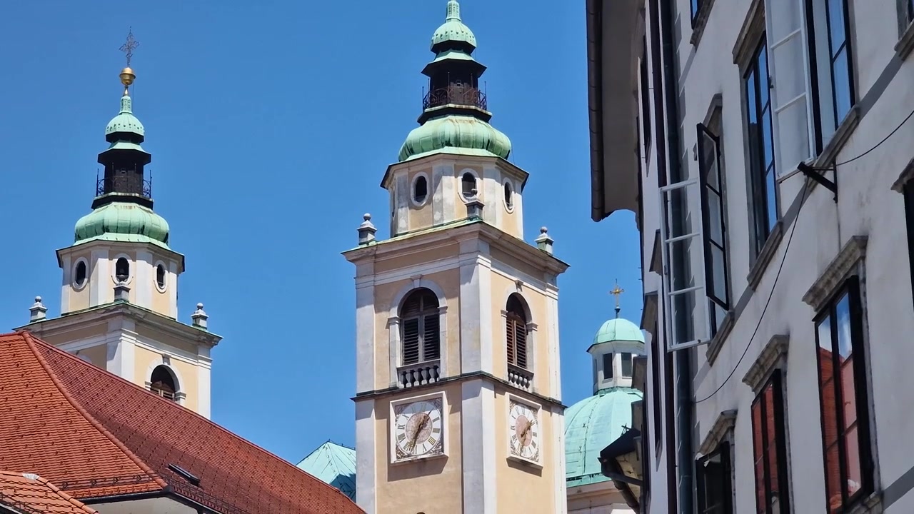 Ljubljana, Slovenia. St. Nicholas Cathedral Bell and Clock Towers on Sunny Summer Day