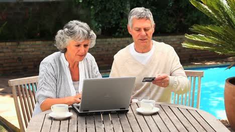 mature couple buying something on internet