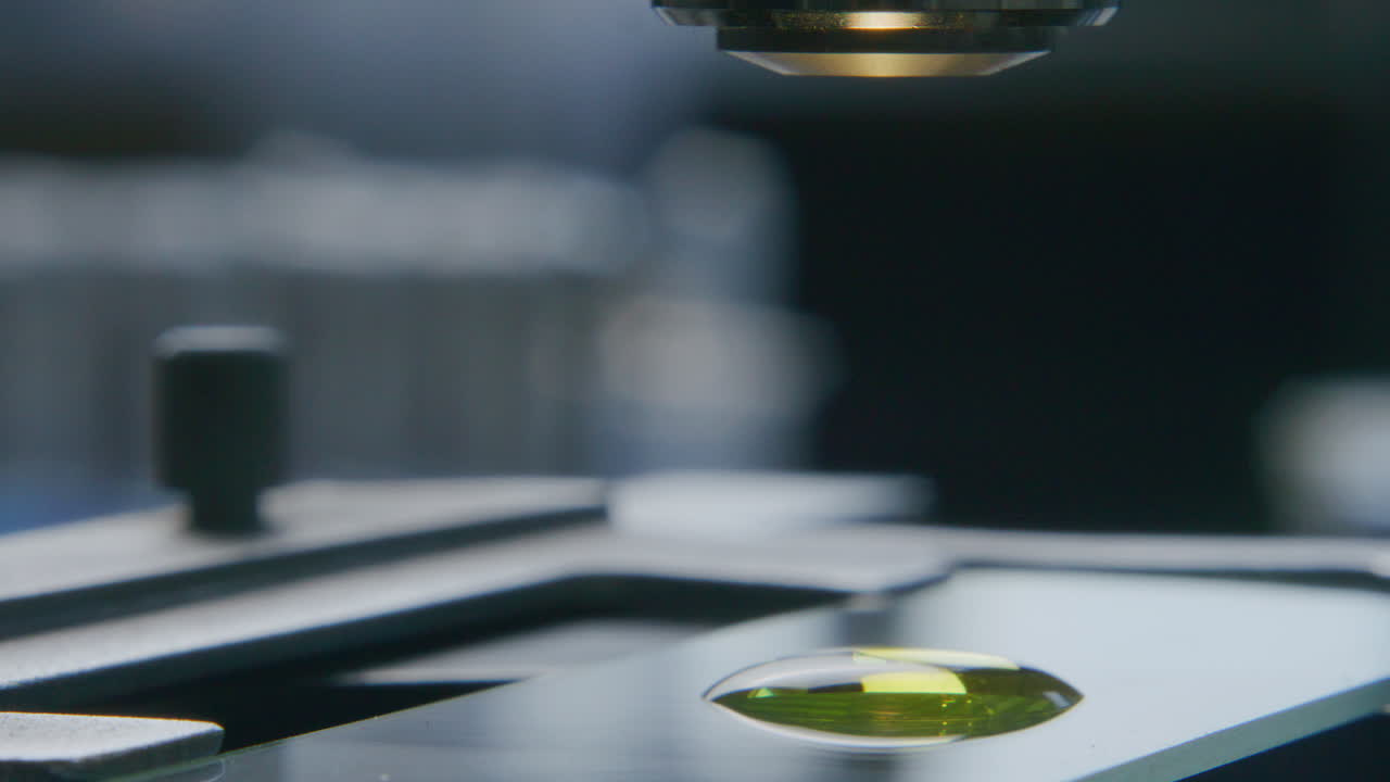 Close Up of Yellow Oil Droplet Being Observed under Microscope