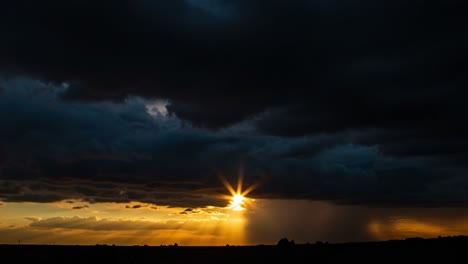 dramatic sky transition: the journey of light breaking through dark clouds with golden rays at sunset over a distant horizon
