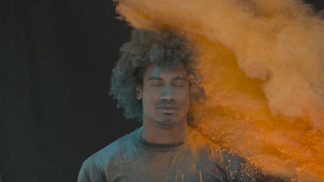 man in color powder explosion slow motion