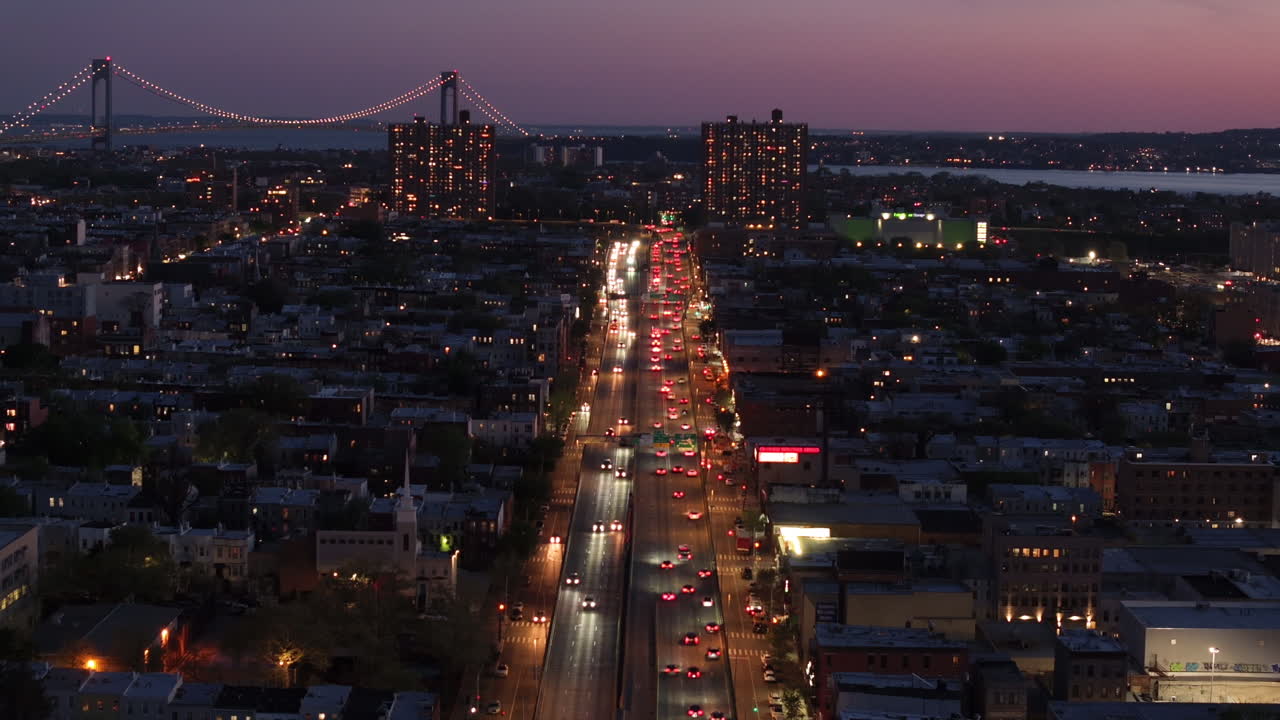 Aerial view of rush hour traffic on Brooklyn's Belt Parkway. Shot at night in Bay Ridge with the Verrazzano Bridge in the background.