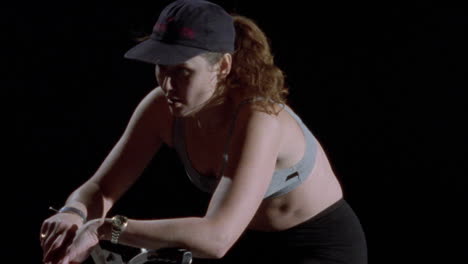 a girl exercises on a stationary bike