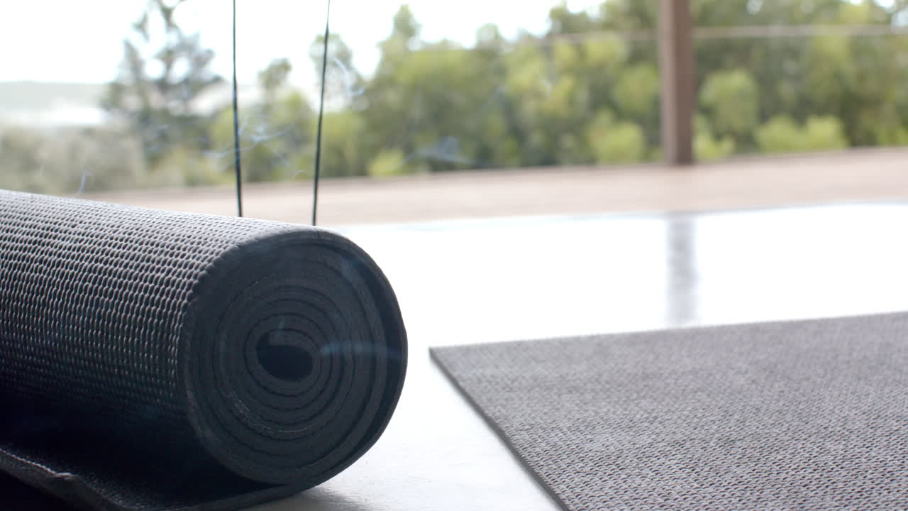 Yoga mat rolled up on floor, ready for home workout or meditation session