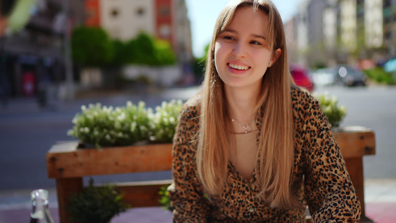 Young woman sitting at a cafe in the city