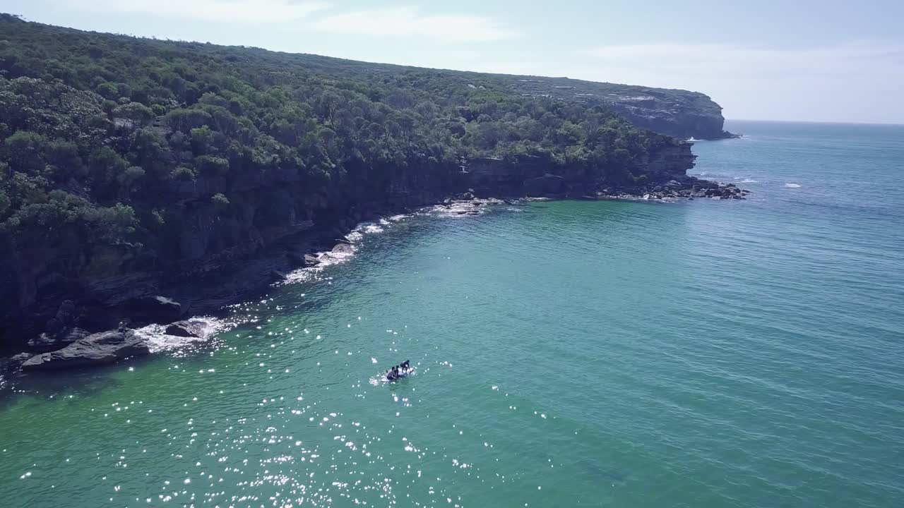 Person Balancing While Practicing Stand-up Paddleboarding In Wattamolla Beach In New South Wales, Australia - aerial