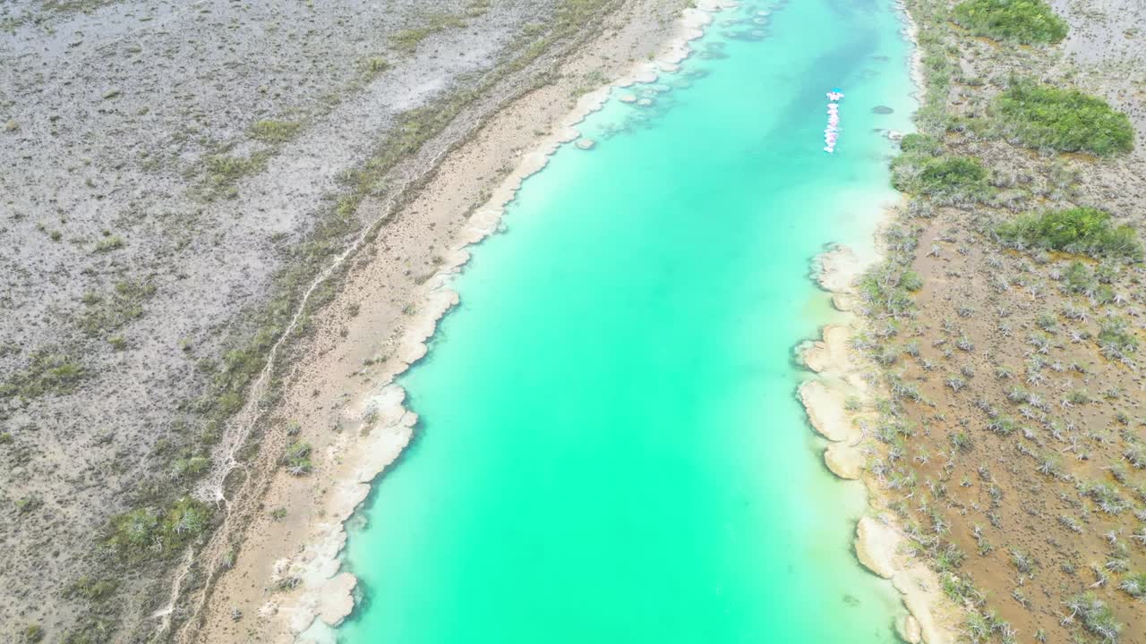 Aerial view of turquoise water and shoreline in Bacalar, Mexico, serene vibe