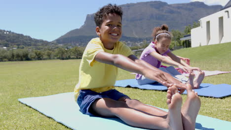 stretching on yoga mats, children exercising outdoors in school field