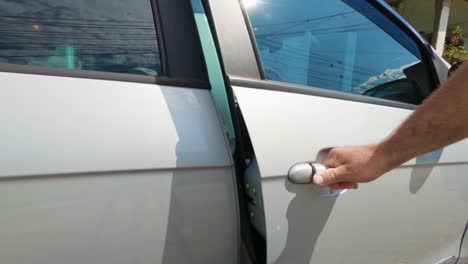 Opening-and-closing-the-door-of-a-gray-car