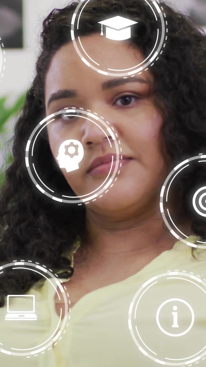 Vertical video: Woman sitting facing camera on start, HUD icons drifting over face showing learning