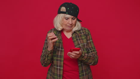 mujer mayor usando tarjeta de crédito bancaria, teléfono inteligente mientras transfiere dinero, compras compras en línea