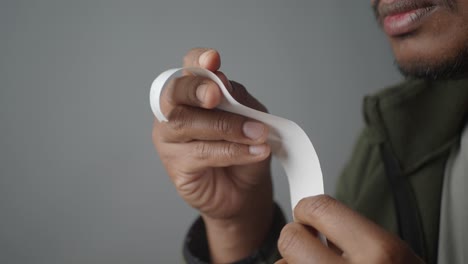 person holding a piece of white tape