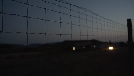 Through-the-fence---cars-driving-in-rural-area