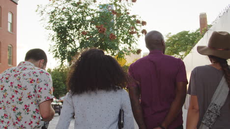 Group-Of-Friends-Walking-Along-Urban-Street-In-New-York-City