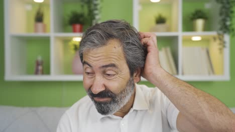 Close-up-mature-man-looks-at-camera-thoughtfully-and-confused.